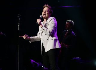 A picture of Olly Murs performing at a concert