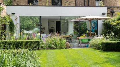 narrow garden with striped lawn and pathway