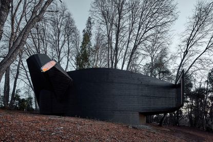 Smiljan Radic's dark coloured and organic shaped House for the Poem of the Right Angle, as we do a Chile tour through his architecture