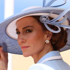 Princess Kate wearing a blue hat and coat