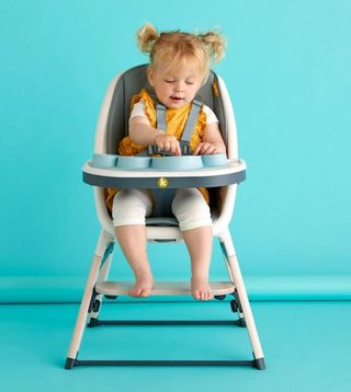 A little girl sits in the Koo-di Tiny Taster 3-in-1 Highchair, our pick of one of the best highchairs