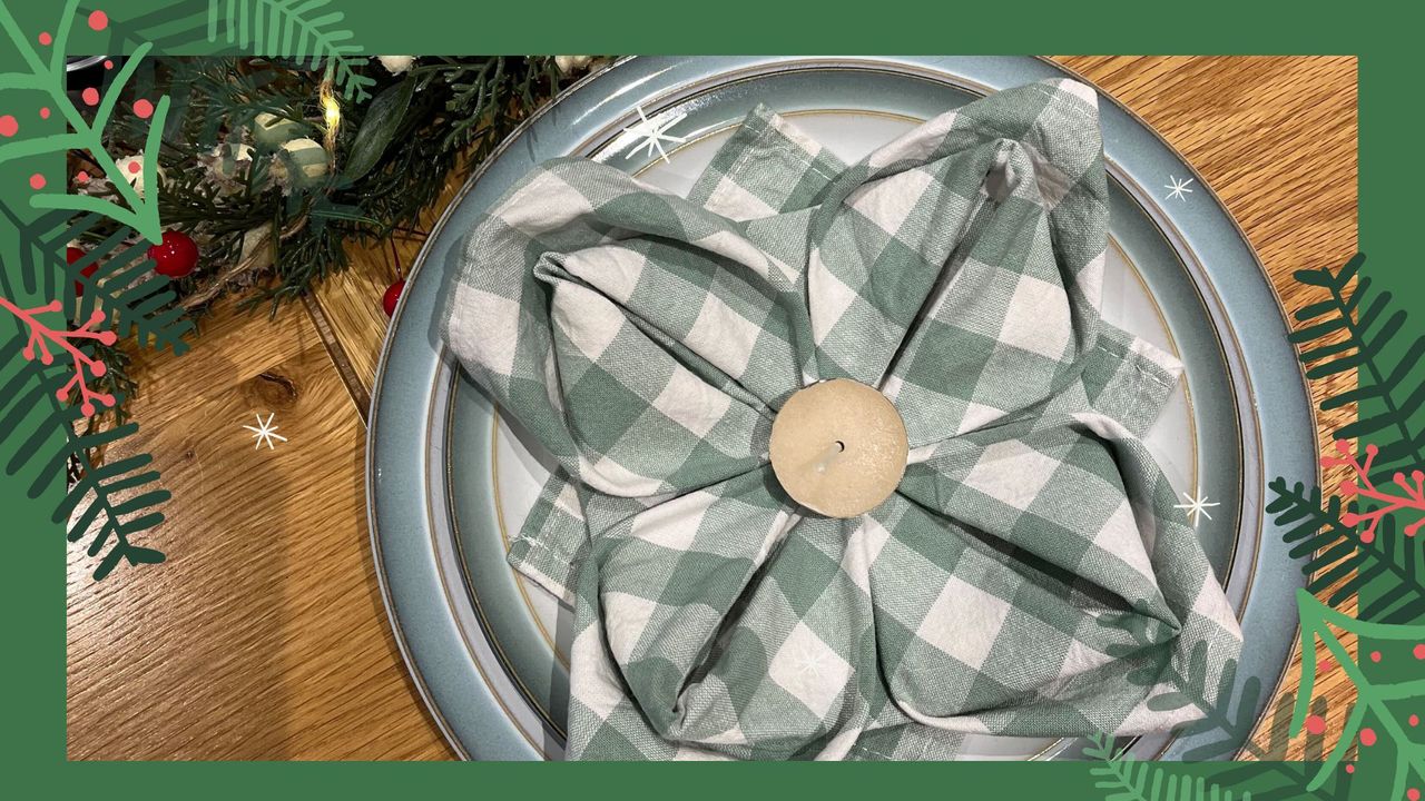 Green gingham napkin folded into a Christmas Poinsettia flower napkin as a place setting