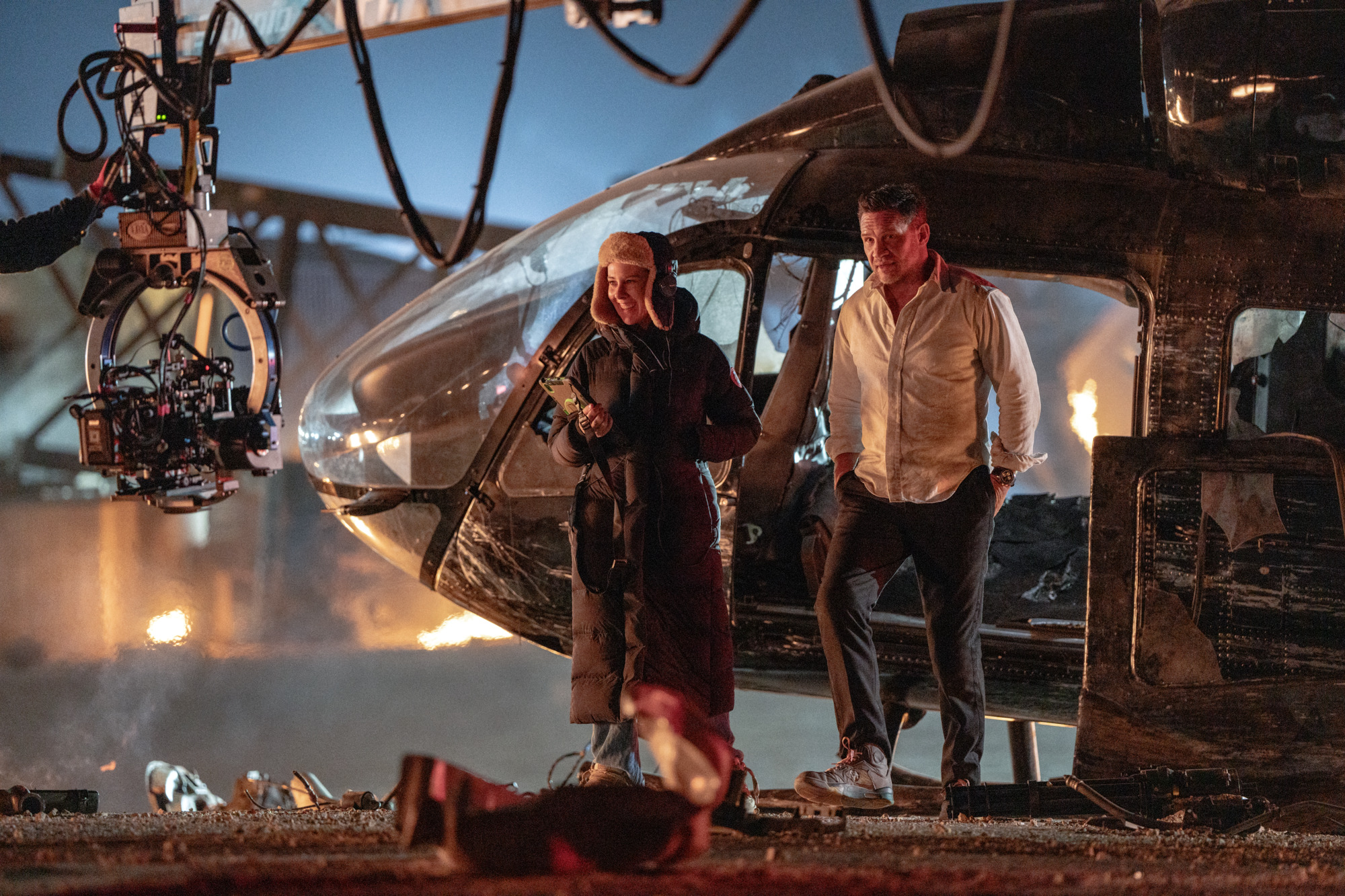 A woman and a man next to a simulated helicopter on a film set