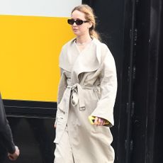 Jennifer Lawrence wears a linen toteme trench coat glasses and on sale nike sneakers in new york city