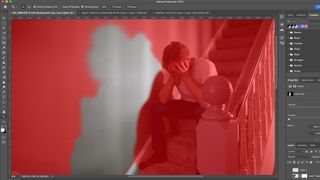 Adobe CC screenshot showing red mask overlay and a man sat on some stairs