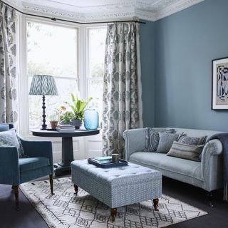 Light blue living room with coordinating blue sofa and soft furnishings