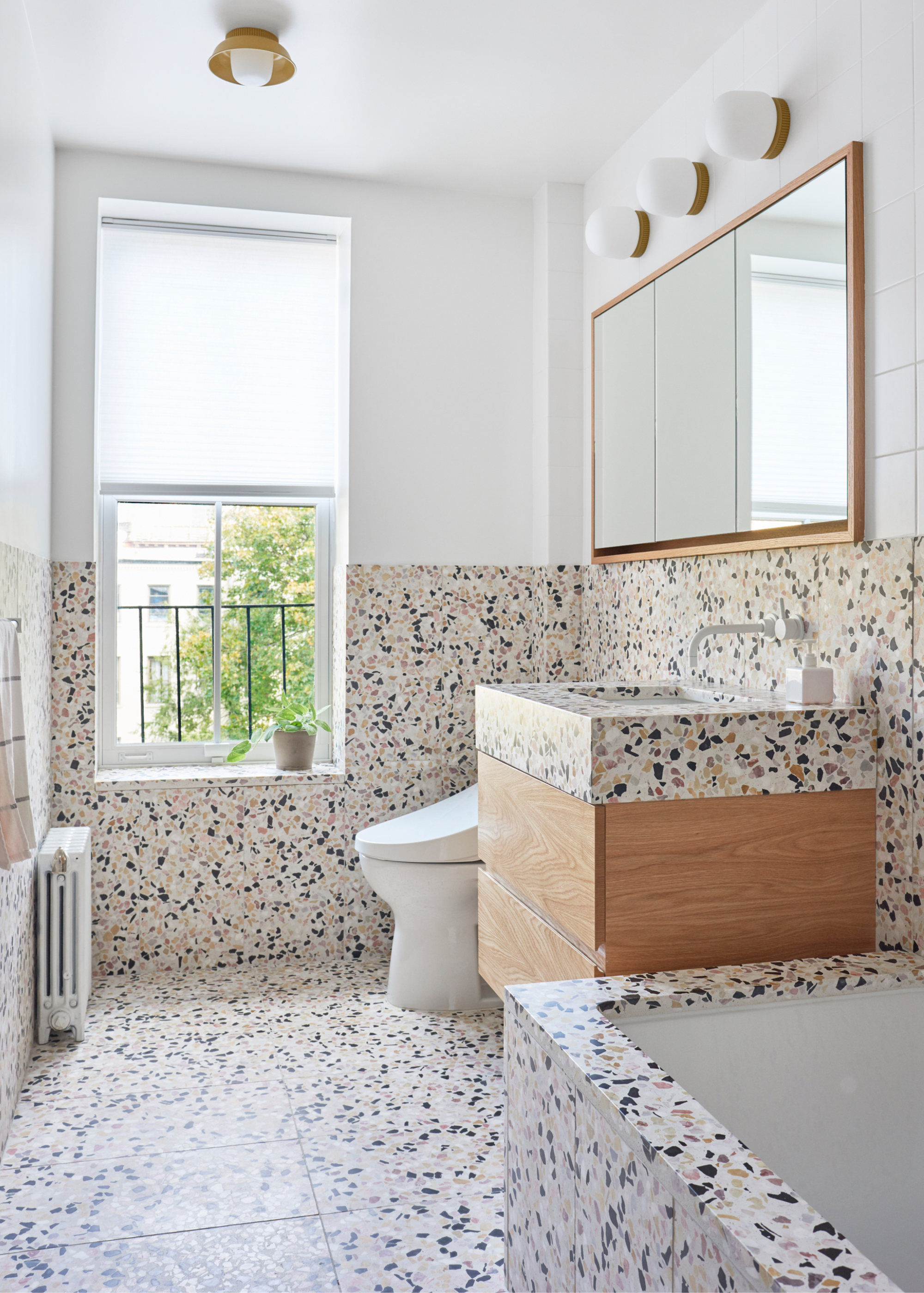 a bathroom with terrazzo tiles used on the floor walls and bathroom vanity