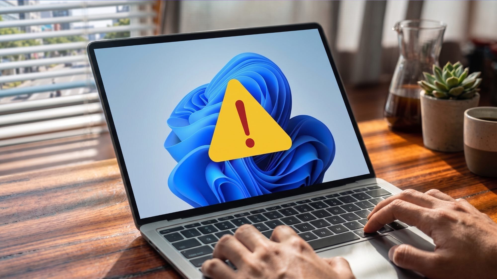 A Windows 11 laptop displaying a large warning sign