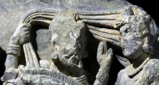 Here, a close-up of the man standing behind Siddhartha in the ancient sculpture.