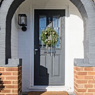 black front door with Christmas wreath