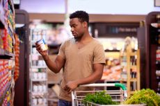 Shot of a young man shopping in a grocery store