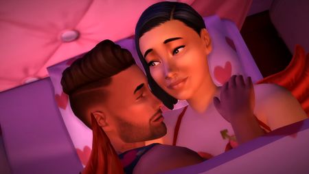 The Sims 4 Lovestruck expansion pack trailer screenshot showing a male and female Sim together in a pink heart-shaped bed