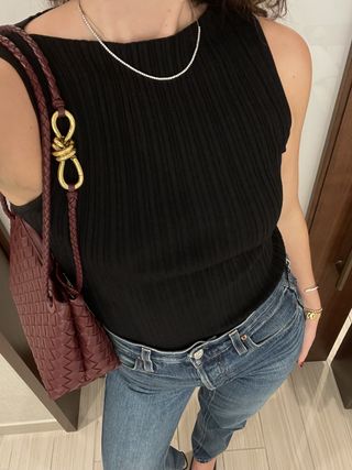 Anna LaPlaca wearing a black Dissh top and Alex Mill jeans
