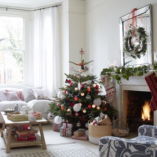 living room with white marble fireplace and christmas tree