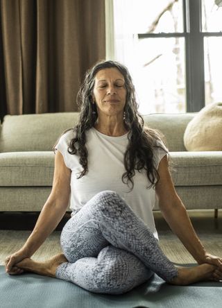 Woman doing yoga with crossed legs