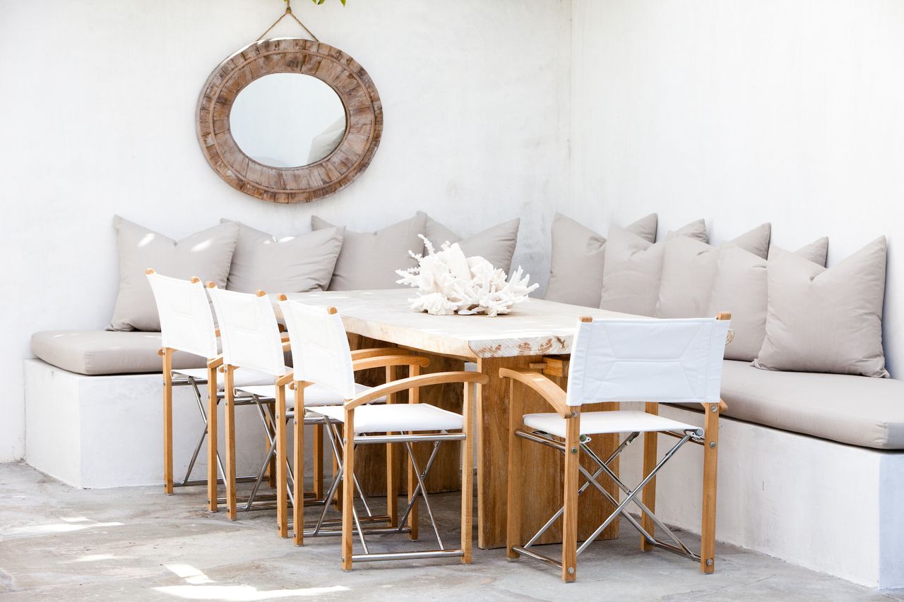 white inbuilt bench with dining table and chairs