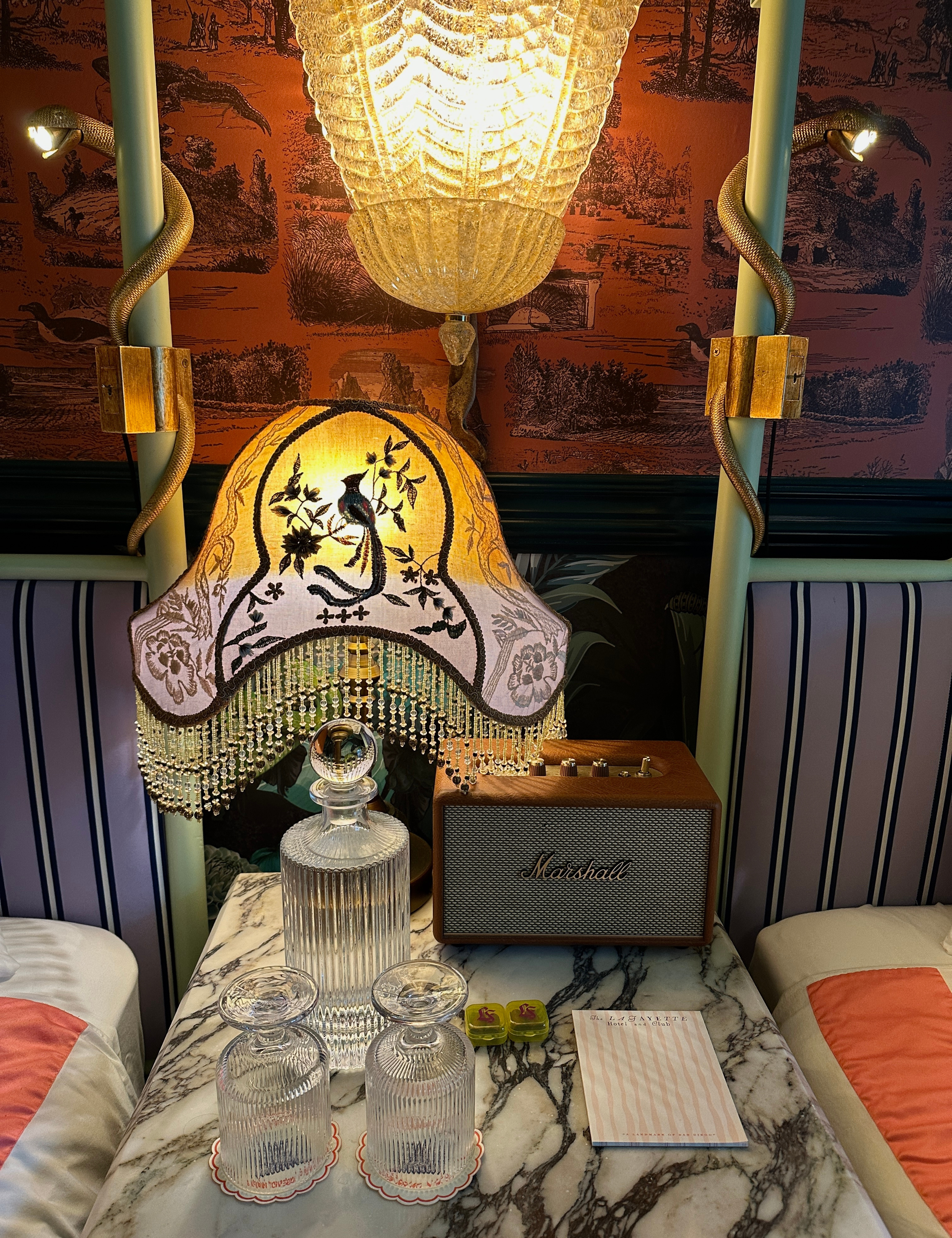 Beaded fringe lamp sitting on a white-and-black marble nightstand