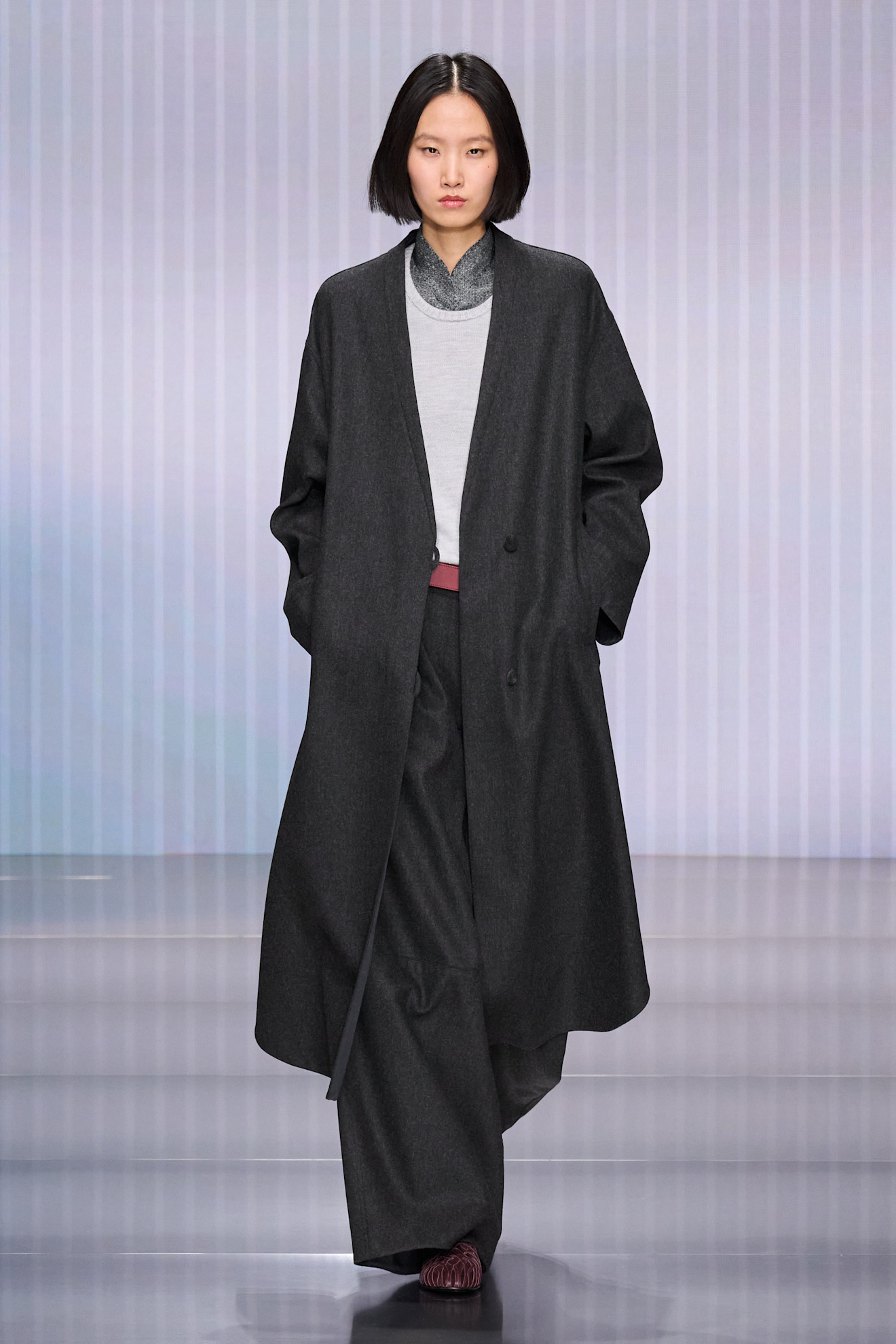 a model walks the giorgio armani show during milan fashion week.