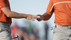 A ball is passed between players during the Ryder Cup