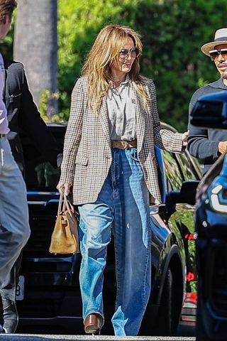 Jennifer Lopez walks in Los Angeles wearing a blazer with baggy jeans and a brown birkin bag