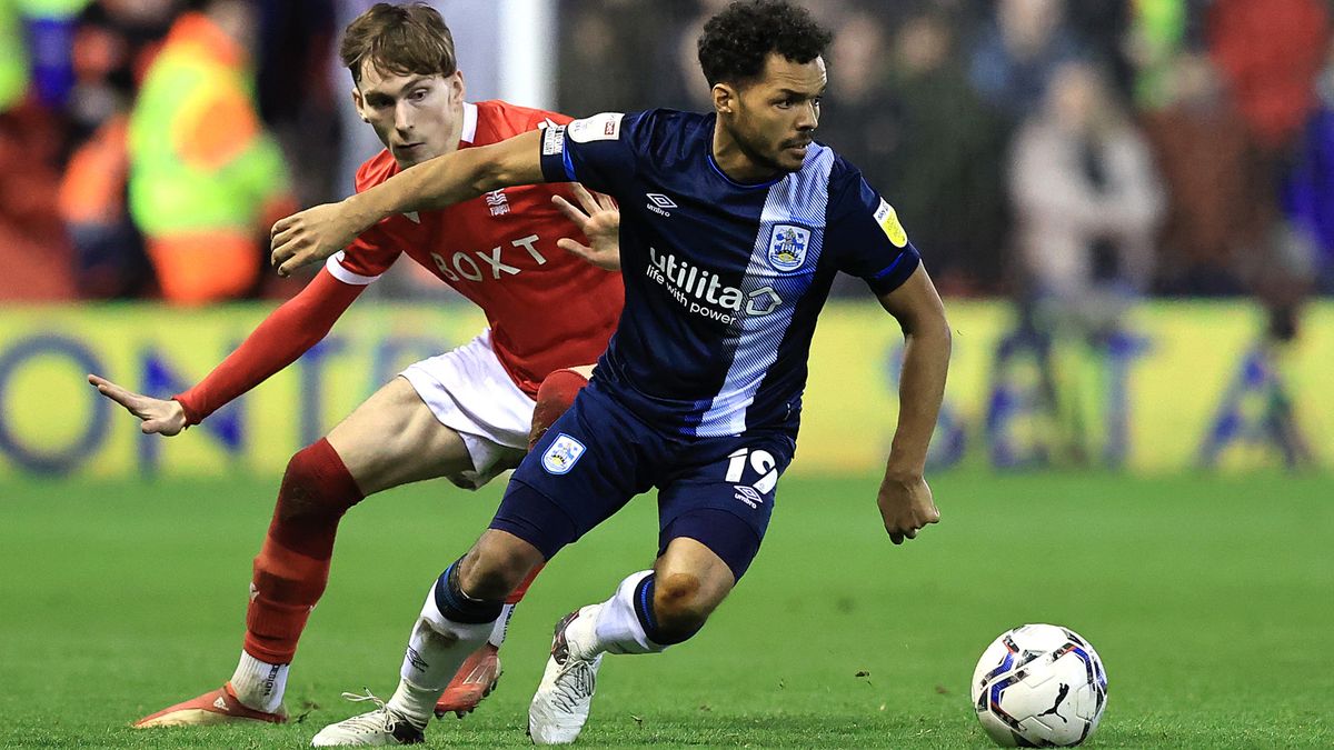 Duane Holmes of Huddersfield Town goes away from James Garner of Nottingham Forest