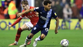 Duane Holmes of Huddersfield Town goes away from James Garner of Nottingham Forest