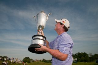 Tom Watson lifts the 2011 Senior PGA Championship trophy aloft