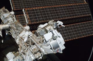 NASA astronauts Andrew Feustel (right) and Greg Chamitoff, both STS-134 mission specialists, appear tiny when compared to their surroundings during the mission's first spacewalk outside the International Space Station on May 20, 2011. The newly-installed