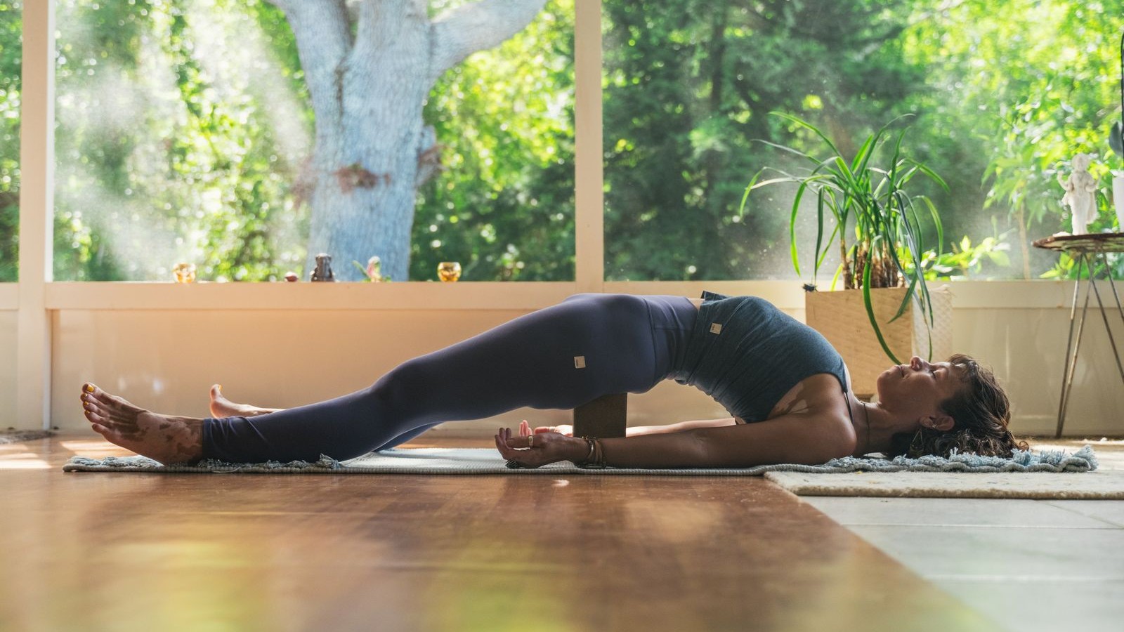 Woman performs yoga pose in studio