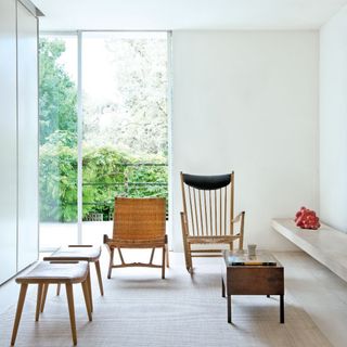 living room with white wall and folding chair with armchair