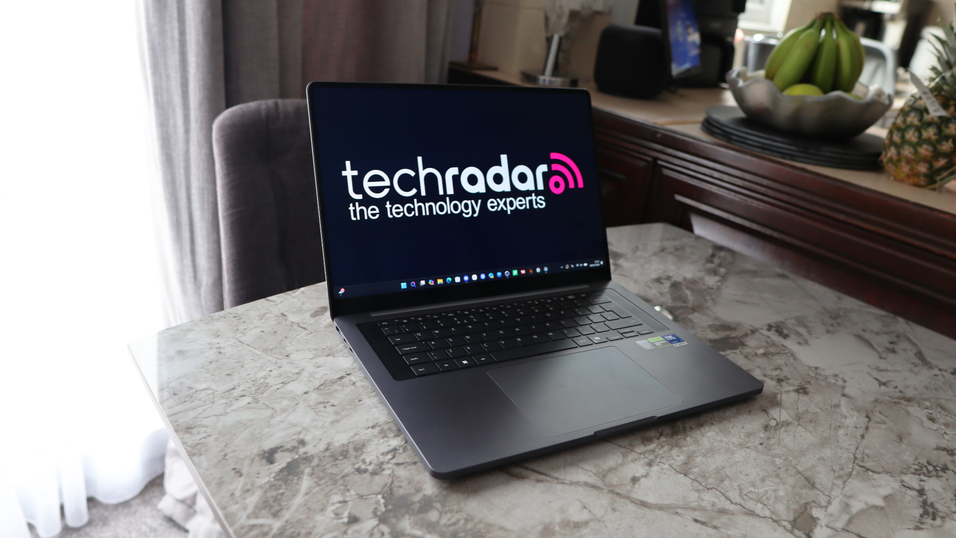 A laptop on a grey worktop surface.