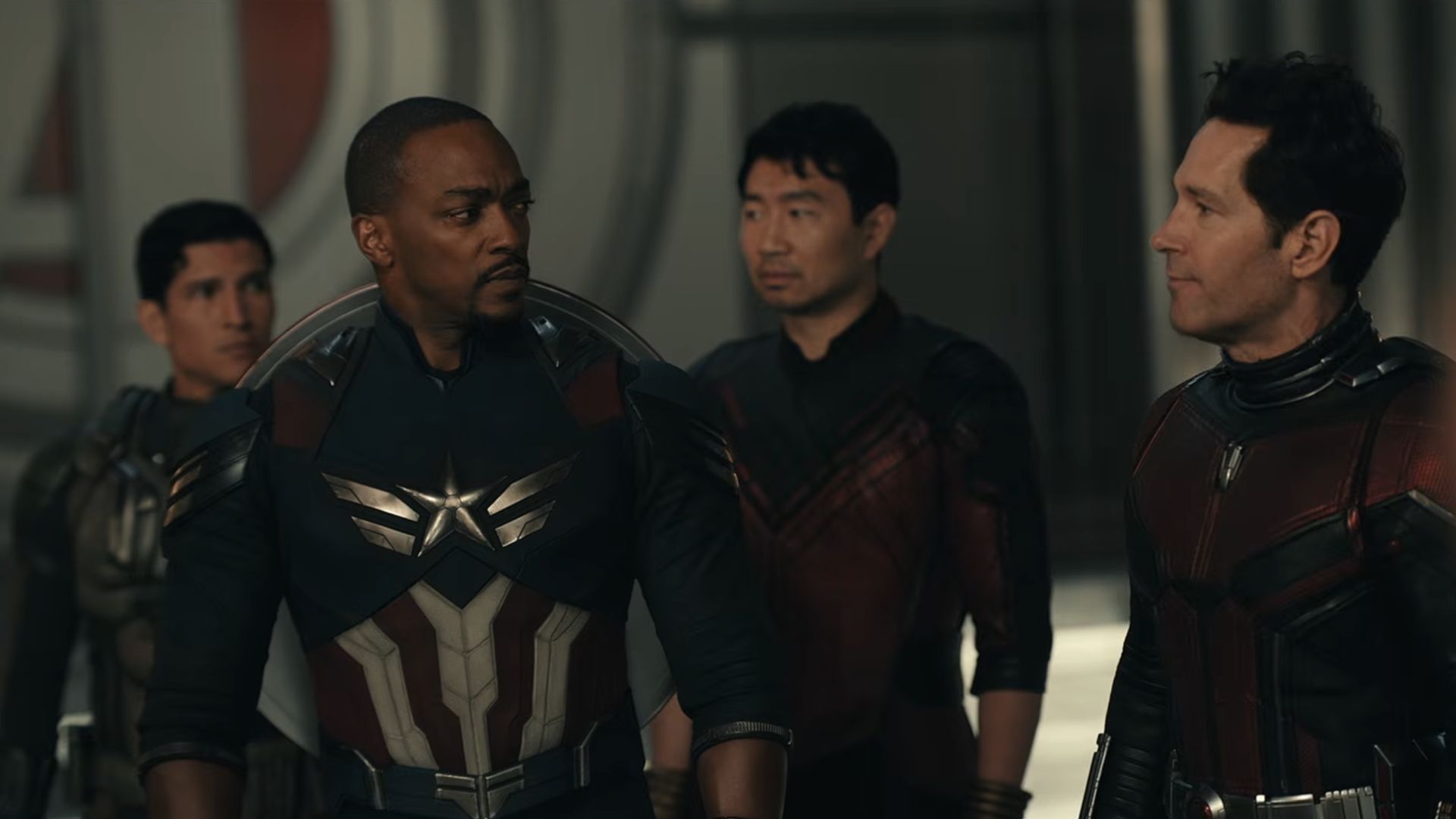 Sam Wilson (Anthony Mackie) looks over at Scott Lang (Paul Rudd) while Joaquin Torres (Danny Ramirez) and Shang-Chi (Simu Liu) stand in the background in Avengers: Doomsday.