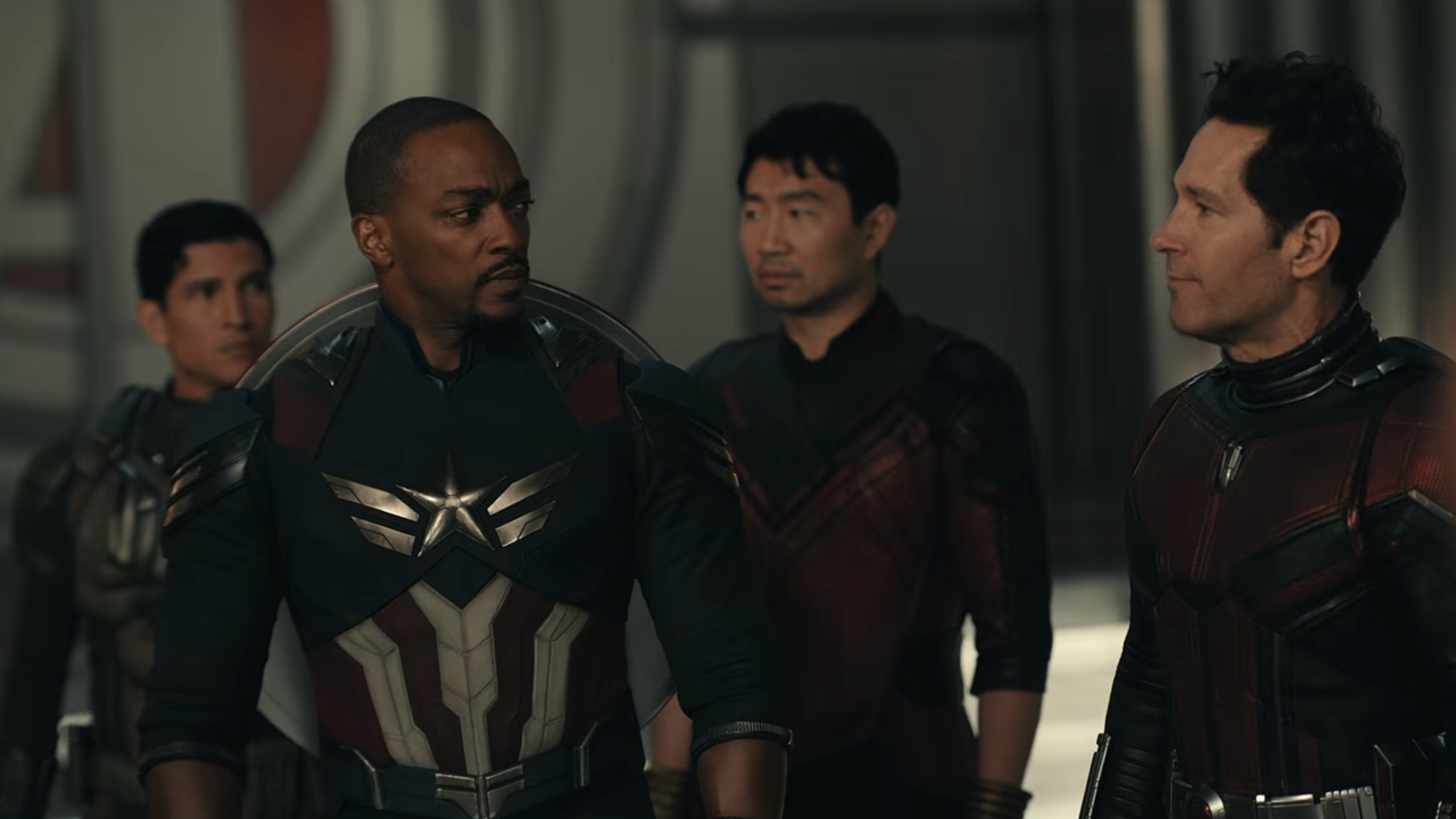 Sam Wilson (Anthony Mackie) looks over at Scott Lang (Paul Rudd) while Joaquin Torres (Danny Ramirez) and Shang-Chi (Simu Liu) stand in the background in Avengers: Doomsday.