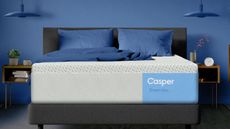 Casper Dream Max on a bed against a blue wall.