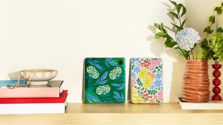 Colorful Kobo cases for the Libra Colour on a shelf with decorative items