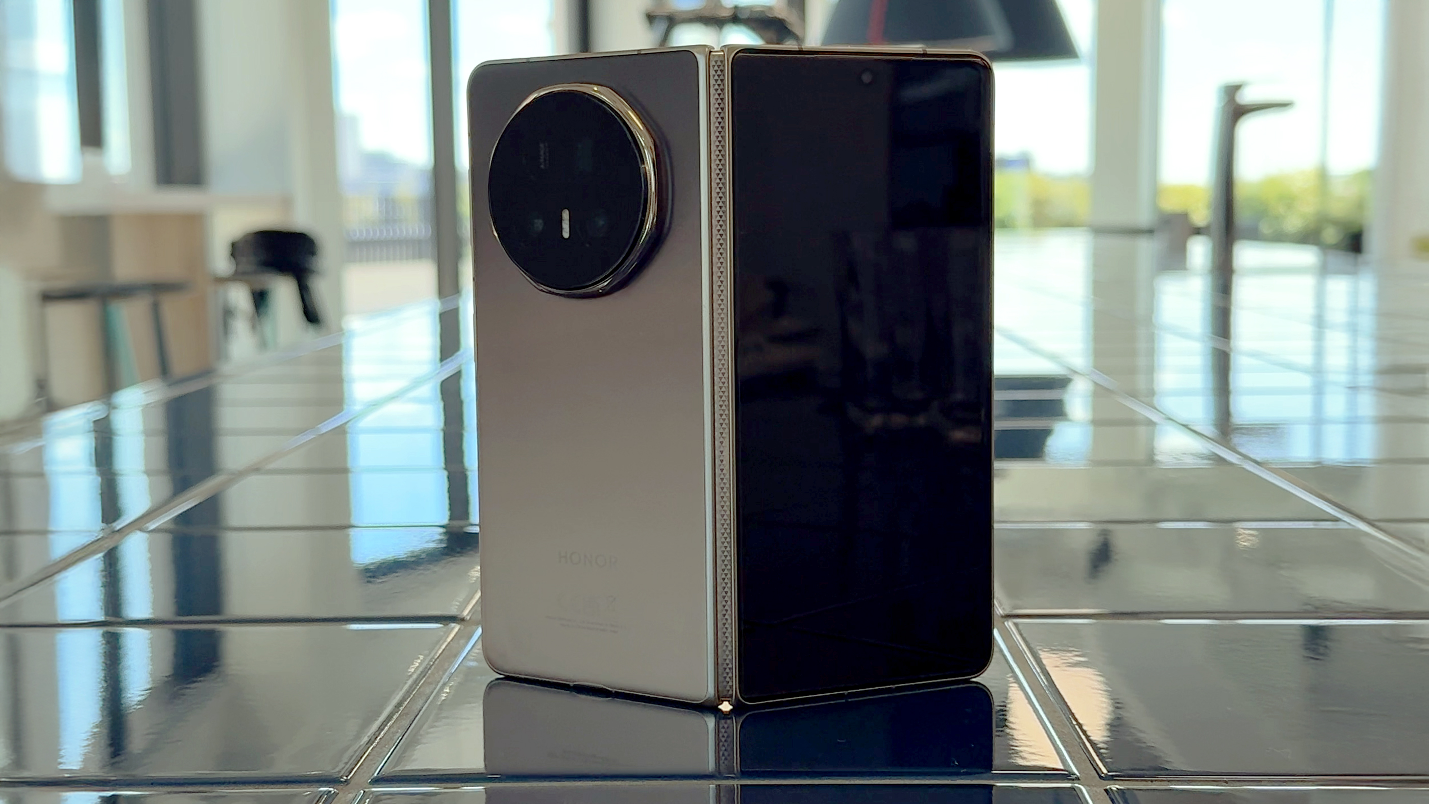 Honor Magic V5 in gold back half-open tiles