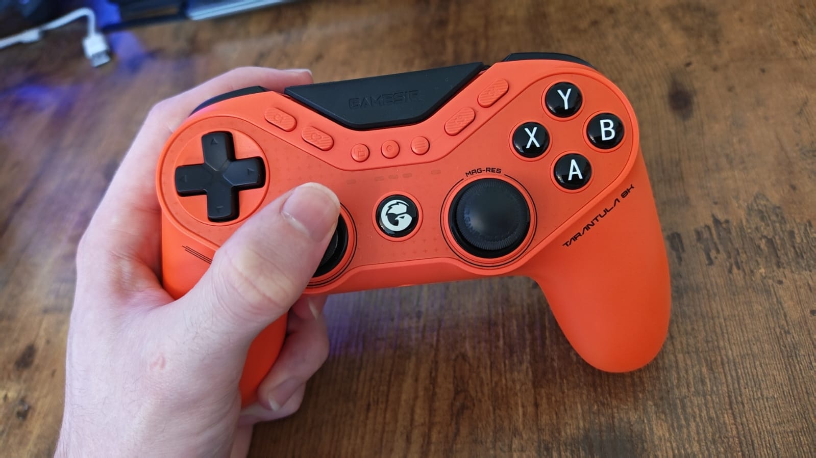 A reviewer holding the GameSir Tarantula 8K