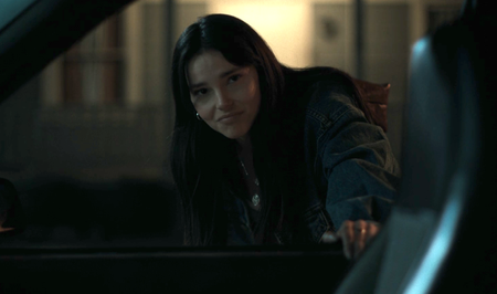 Inde Navarette as Nikki leaning on Bear's car in Obsession