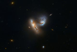 What looks like a delicate dance between two galaxies is actually a slow-motion collision of colossal proportions in this Hubble Space Telescope photo. The two galaxies, called UGC 2369, are merging into one about 424 million light-years from Earth.