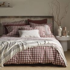 Secret Linen Store's Conker Gilbert Gingham brushed cotton bedding on a bed in a neutral bedroom