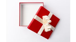 An open empty gift box wrapped in shiny red paper and wide white ribbon