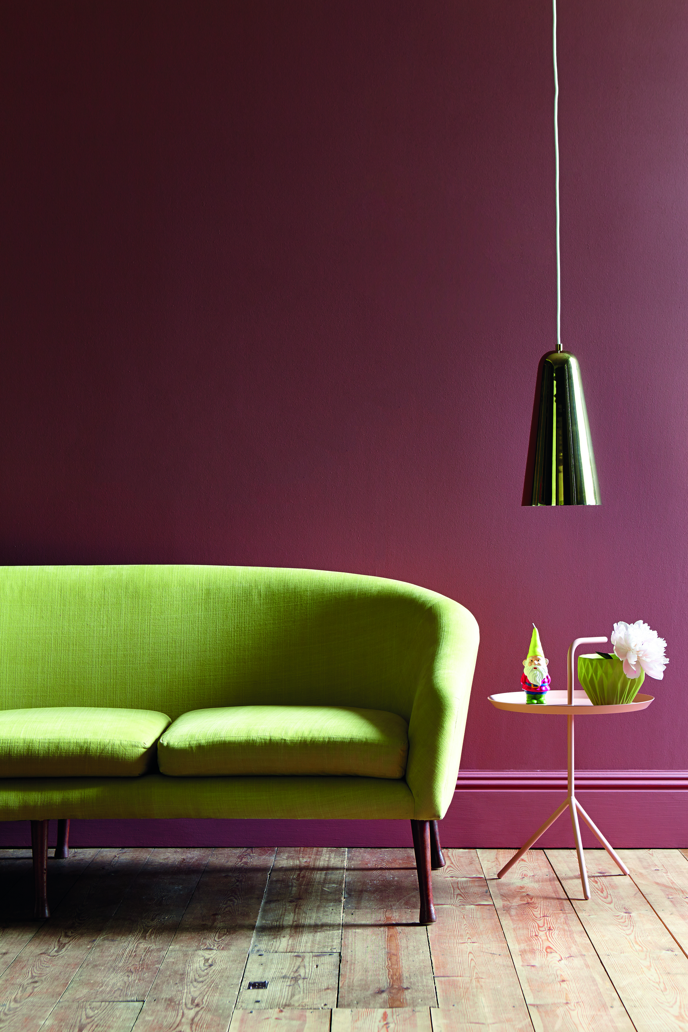 Burgundy living room with lime green sofa by Little Greene