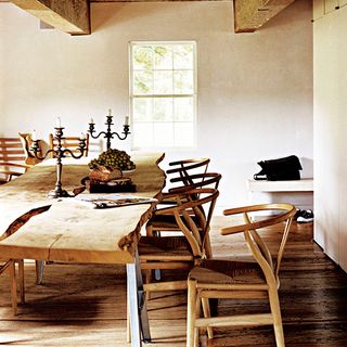 dining room with raw edged wood table and wishbone chairs