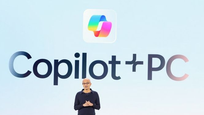 Copilot Plus slide with Satya Nadella standing in front of it onstage at Build 2024