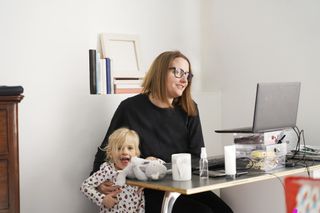 Mum working from home on conference call interrupted by child