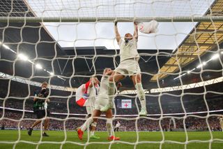 Lucy Bronze of England hangs on the goal post as she celebrates after the 2-1 win during the UEFA Women's Euro 2022 final match between England and Germany at Wembley Stadium on July 31, 2022 in London, England