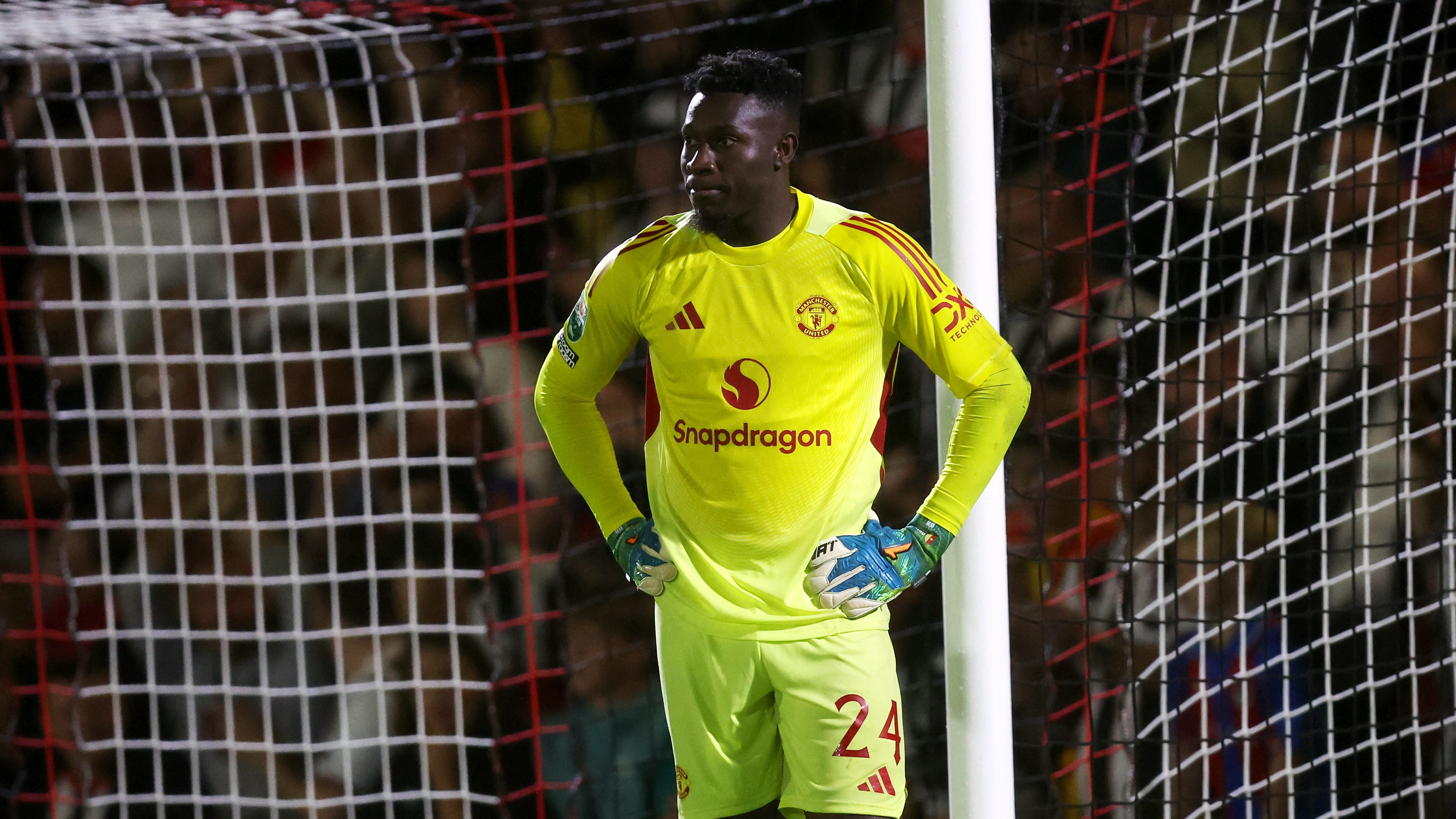 Andre Onana of Manchester United looks dejected after failing to save a penalty from Darragh Burns (not pictured) of Grimsby Town during the Carabao Cup Second Round match between Grimsby Town and Manchester United at Blundell Park on August 27, 2025 in Grimsby, England.