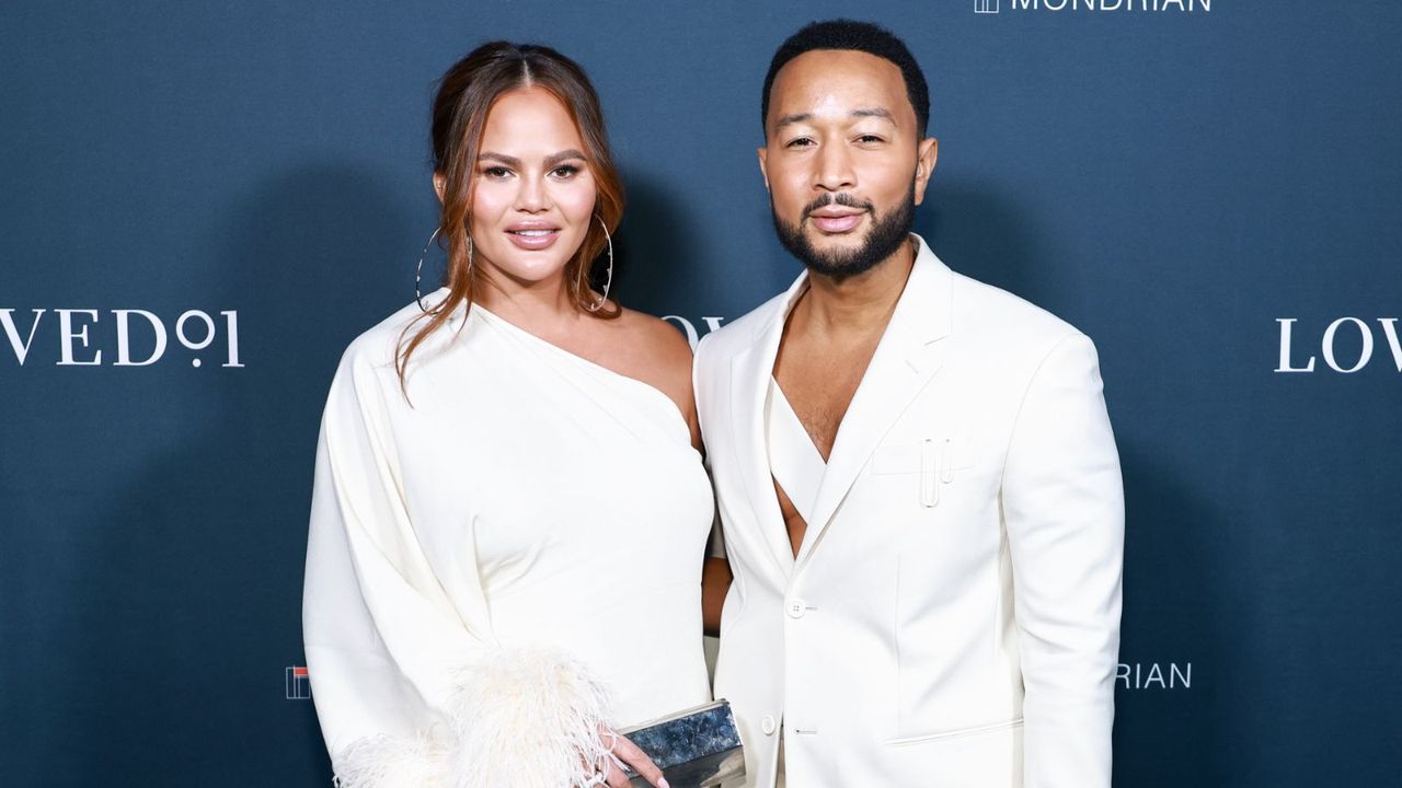 john legend and chrissy teigen on a blue background