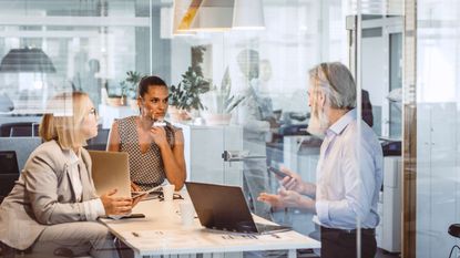 Three people working together in an office