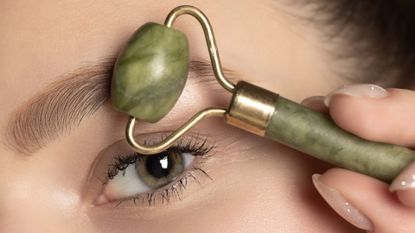 woman using a jade eye roller